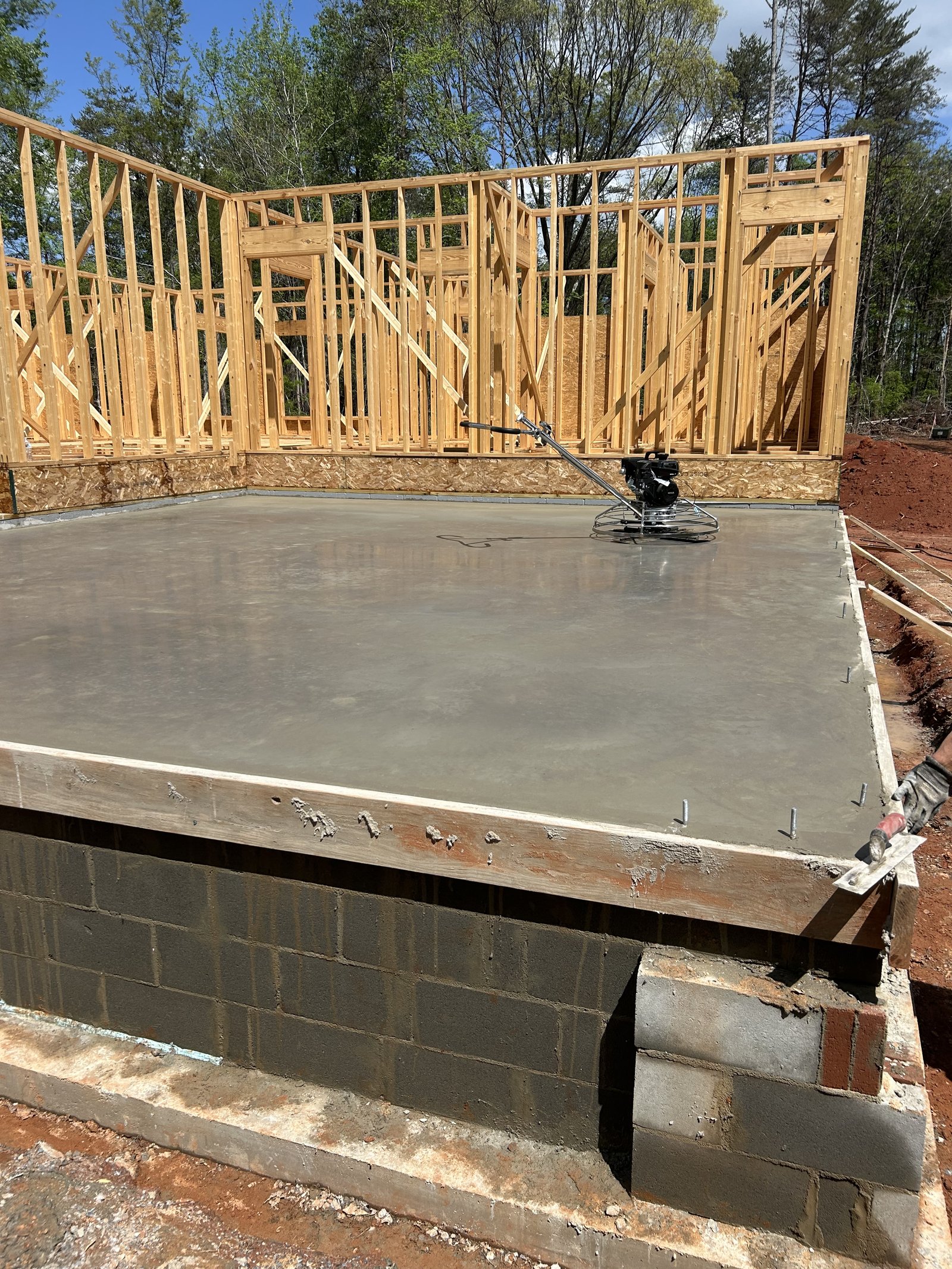 Concrete foundation slab being finished with power trowel in Spartanburg SC
