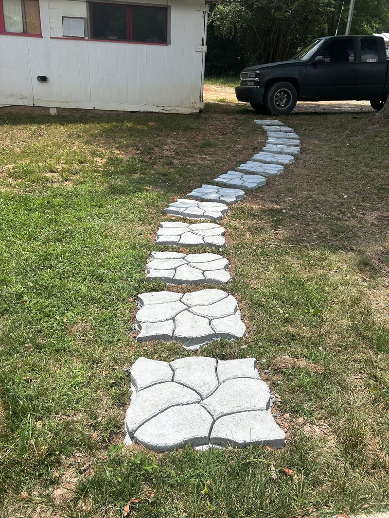 Concrete stepping stone path through grassy yard in Cherokee County SC