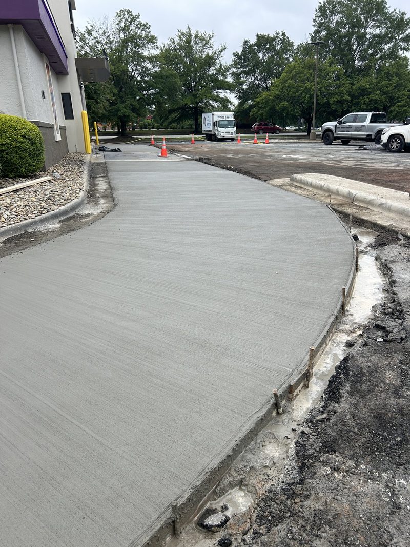 Broom finish concrete sidewalk alongside commercial building in Spartanburg SC