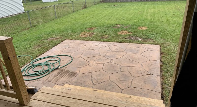 Large stamped concrete patio in residential backyard in South Carolina