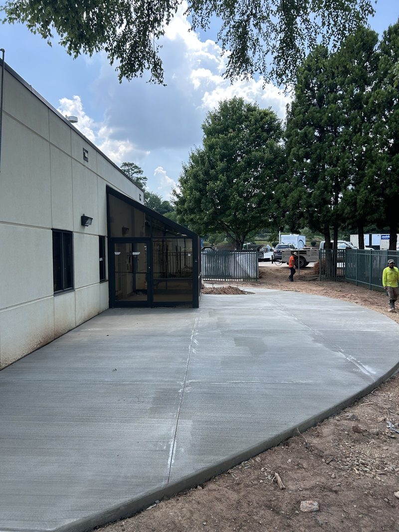 Newly poured broom finish concrete patio next to commercial building in Spartanburg SC