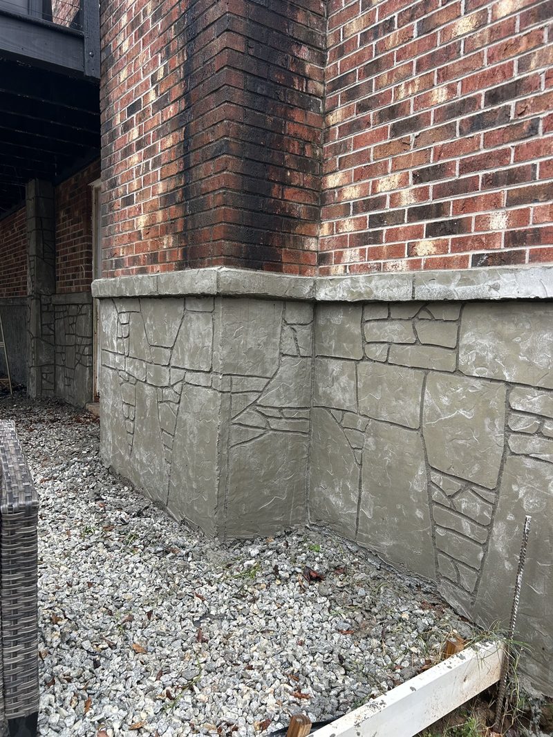 Stamped concrete foundation with stone pattern below brick wall in Spartanburg SC